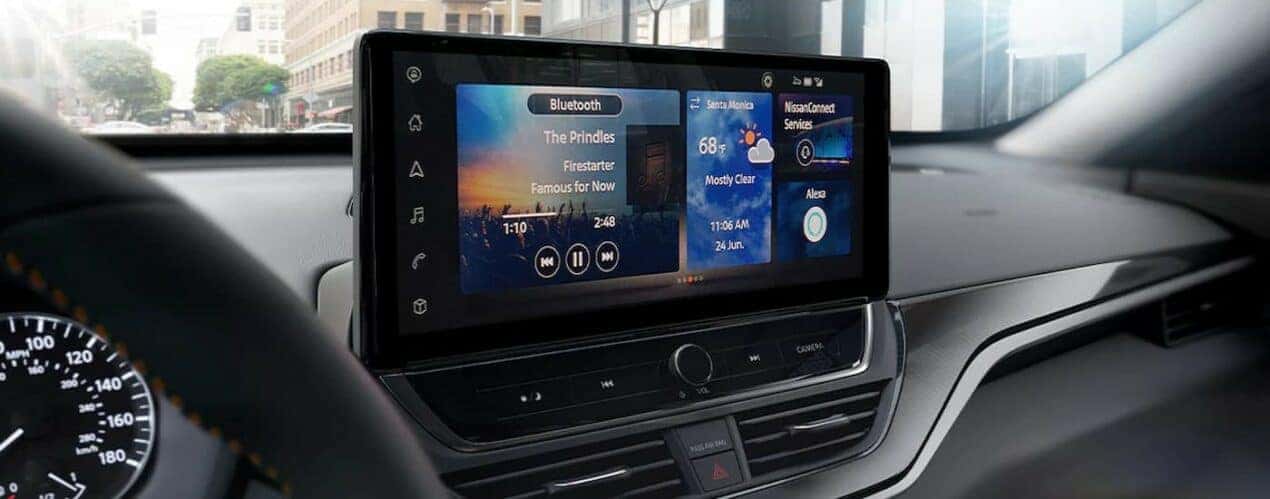 A close-up of the infotainment screen is shown in a 2024 Nissan Altima.