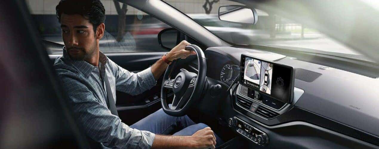 The black interior and dash in a 2024 Nissan Altima is shown.