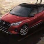 A red 2024 Nissan Kicks SV is shown parked from a high angle after a 2024 Nissan Kicks vs 2024 Chevy Trax comparison.