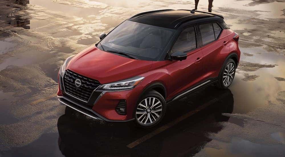 A red 2024 Nissan Kicks SV is shown parked from a high angle after a 2024 Nissan Kicks vs 2024 Chevy Trax comparison.