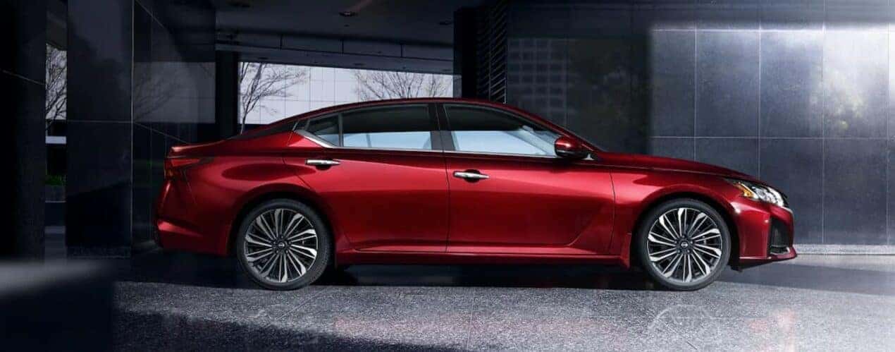 A red 2024 Nissan Altima SL is parked during a 2024 Nissan Altima vs 2024 Kia K5 comparison.