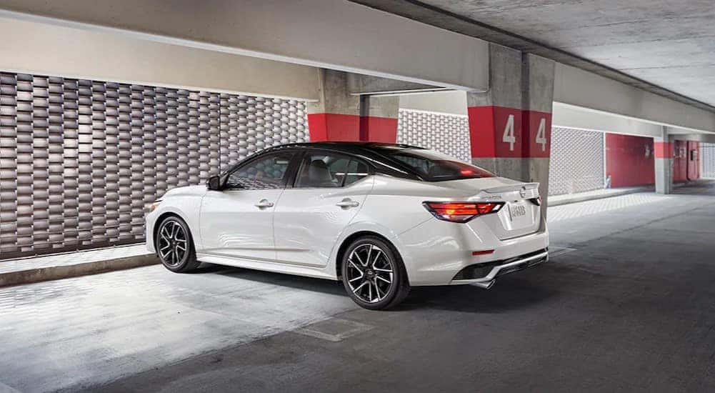 A white 2024 Nissan Sentra is shown parked in a parking garage.