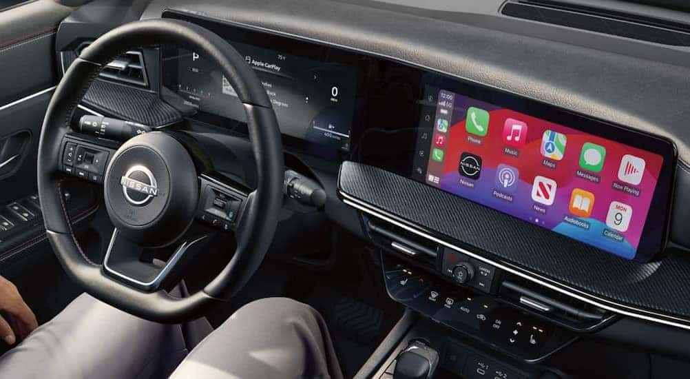 The black interior and dash in a 2025 Nissan Kicks is shown.