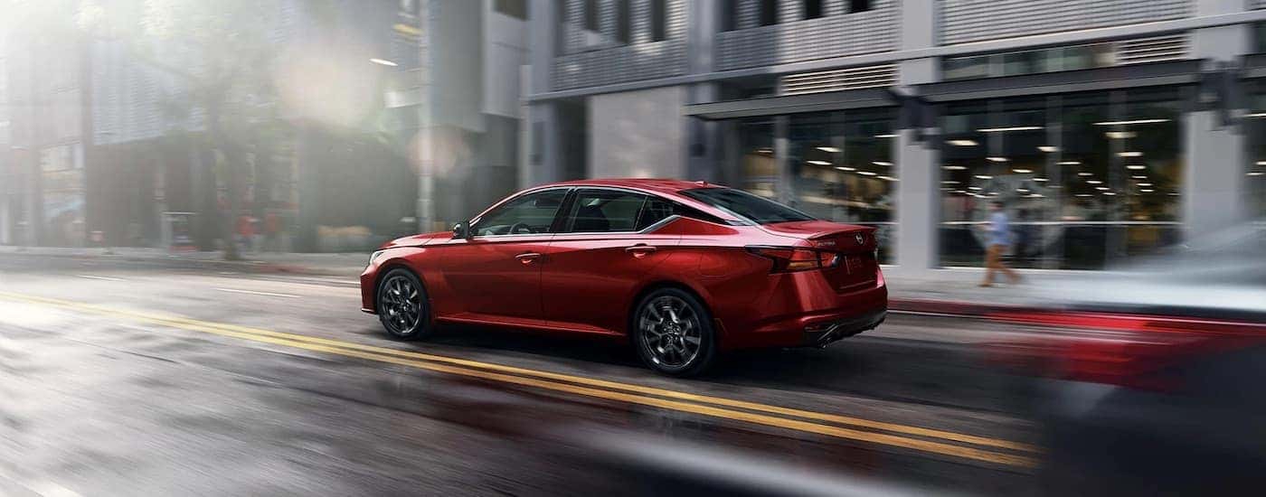 A red 2023 Nissan Altima is shown from the rear at an angle.