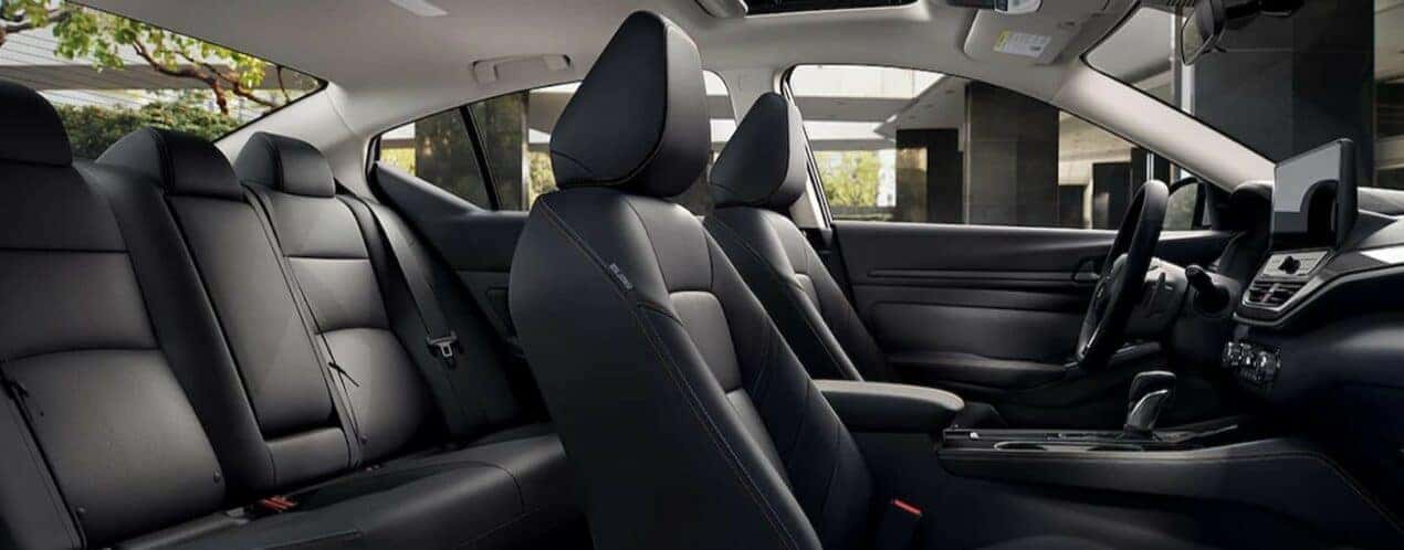 The black interior and dash in a 2024 Nissan Altima is shown.