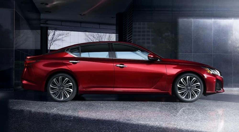 A red 2024 Nissan Altima SR is shown parked on a driveway.