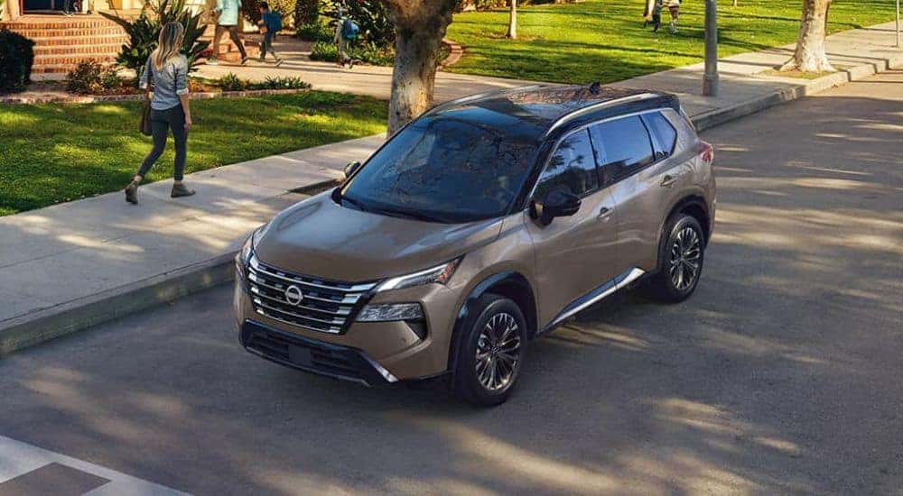 A grey 2024 Nissan Rogue is shown parked at a crosswalk.