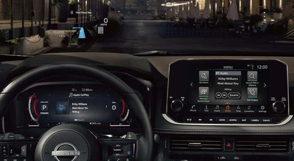 A close-up of the black dash and digital displays in a 2024 Nissan Rogue is shown.