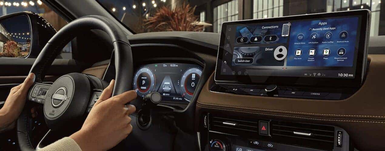 A close up of the dashboard and steering wheel in a 2024 Nissan Rogue.
