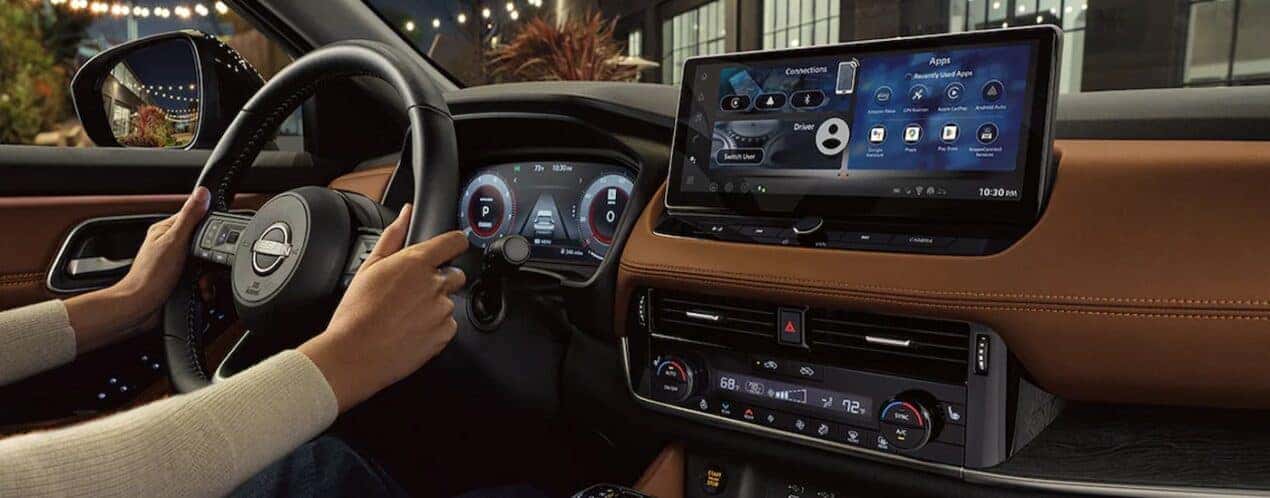 The black and brown interior and dash in a 2024 Nissan Rogue is shown.