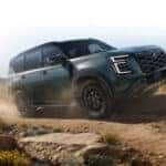 A green 2025 Nissan Armada is shown from the front at an angle.