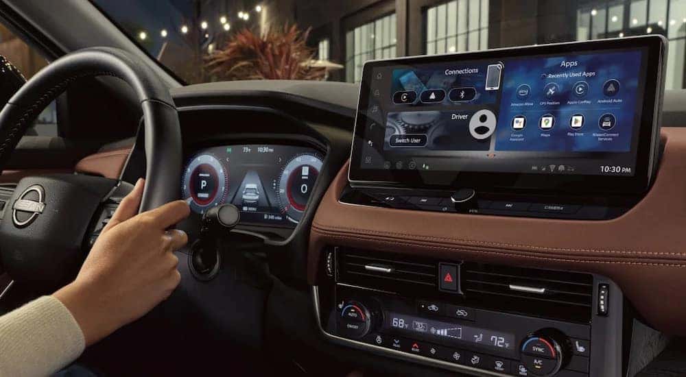 The dash of a 2024 Nissan Rogue is shown from the driver's seat.