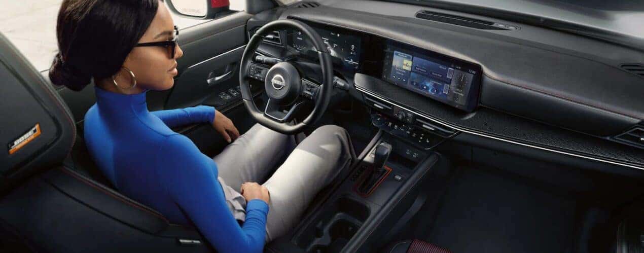The black interior and dash are shown in a 2025 Nissan Kicks SR.