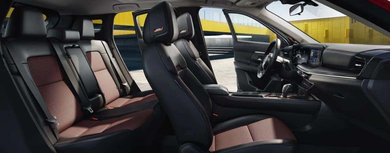 The black and brown interior and dash are shown in a 2025 Nissan Kicks SR.