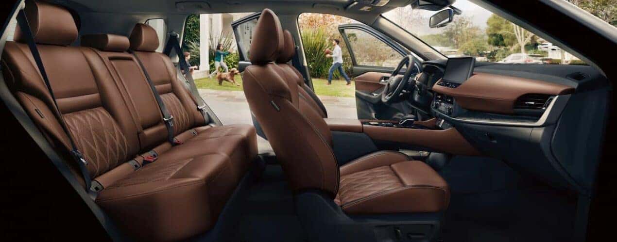 The black and brown interior is shown in a 2025 Nissan Rogue Platinum.