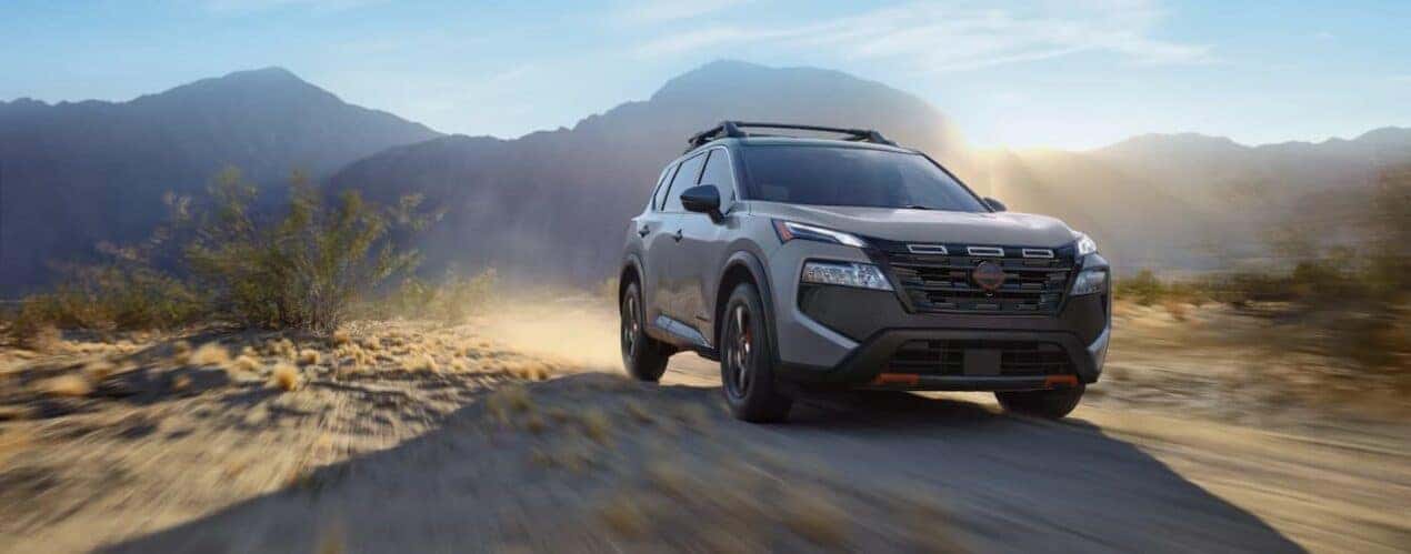 A gray 2025 Nissan Rogue Rock Creek is shown driving off-road.