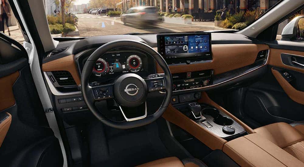 Brown upholstery and digital information displays in a 2025 Nissan Rogue Platinum.