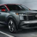 A grey 2025 Nissan Kicks SR is shown from the front at an angle during a 2025 Nissan Kicks vs 2025 Chevy Trax comparison.