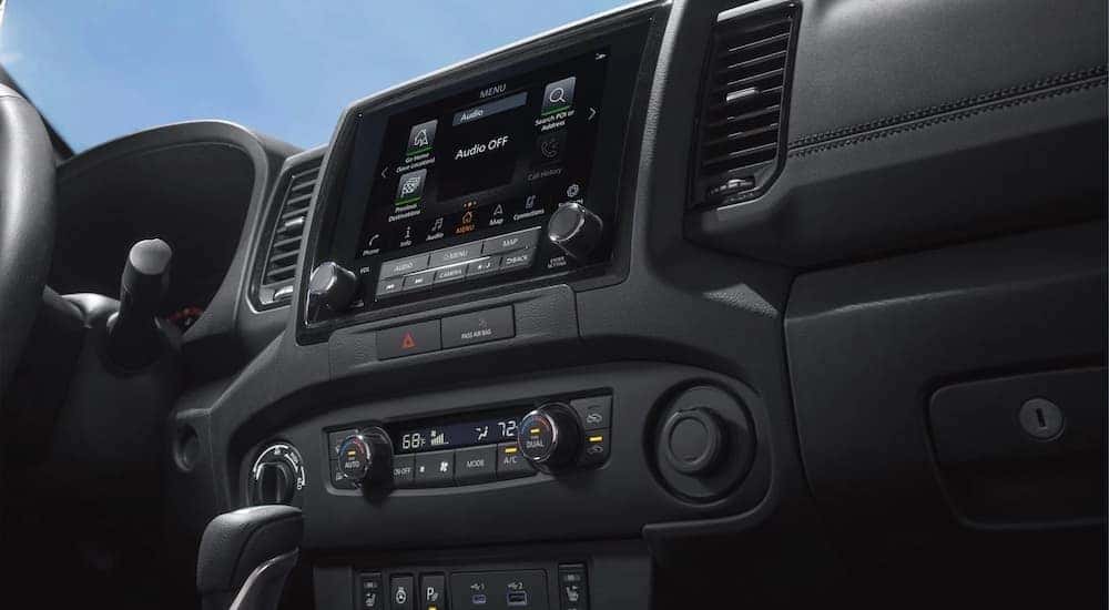 The black interior of a 2025 Nissan Frontier is shown.