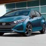 A blue 2025 Nissan Versa SR is shown parked after visiting a Nissan dealer.