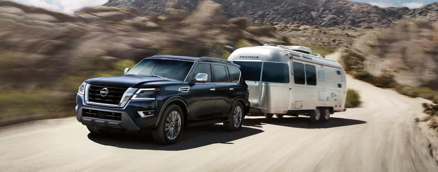 A black 2024 Nissan Armada Platinum towing an Airstream trailer.