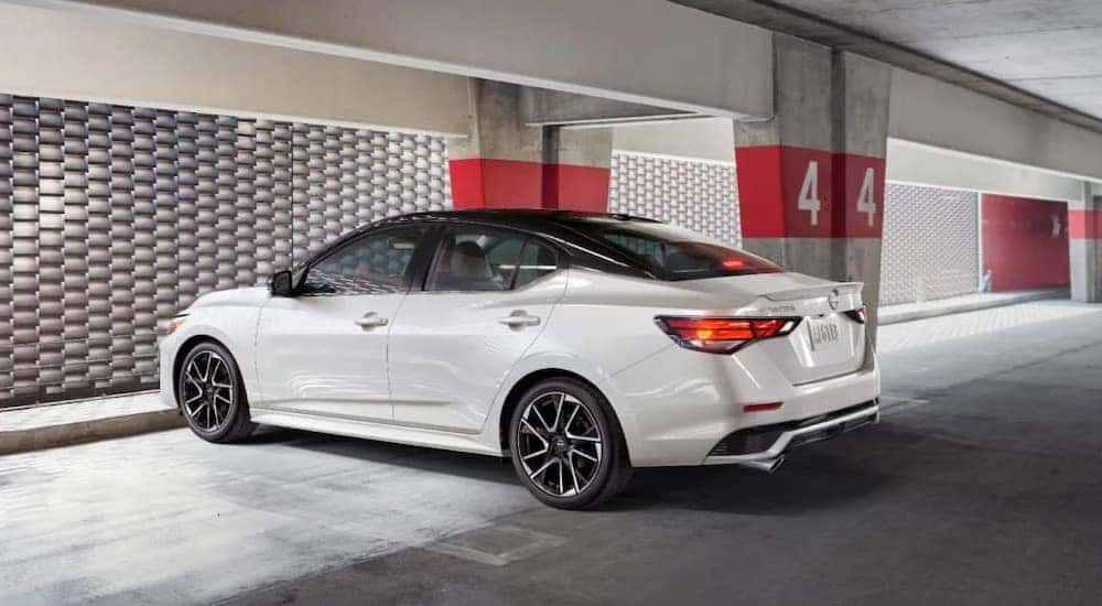 A white 2025 Nissan Sentra SR is shown parked in a parking garage.