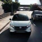 A white and black 2025 Nissan Sentra SR are shown driving on a highway.