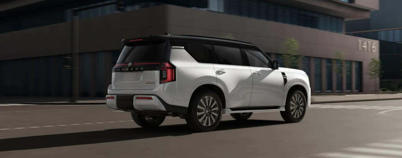 A white 2025 Nissan Armada for sale is shown from the rear at an angle.