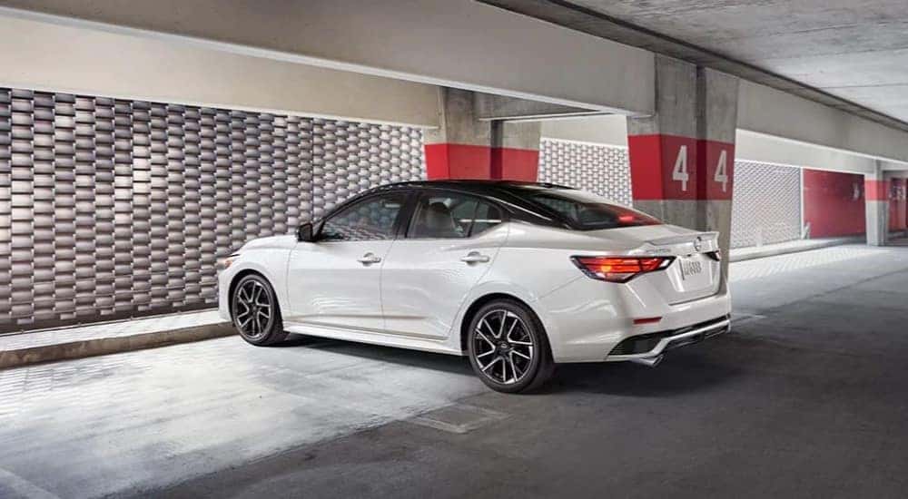 Rear view of a white 2025 Nissan Sentra parked in a garage.