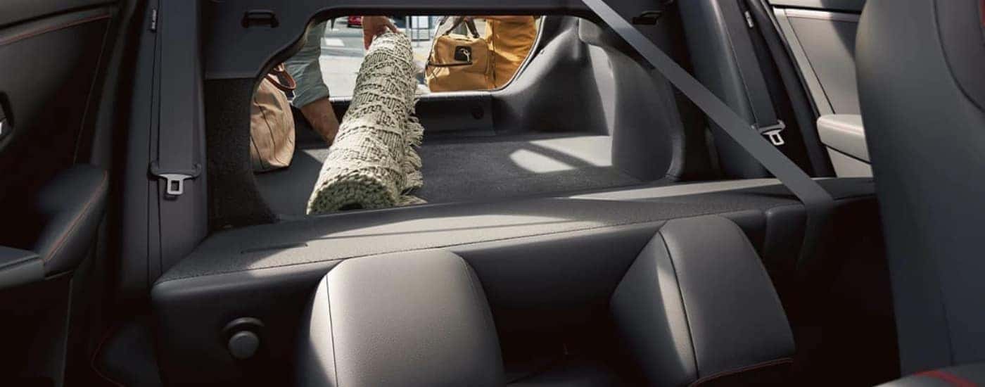 A rug is shown in the trunk of a 2024 Nissan Sentra.