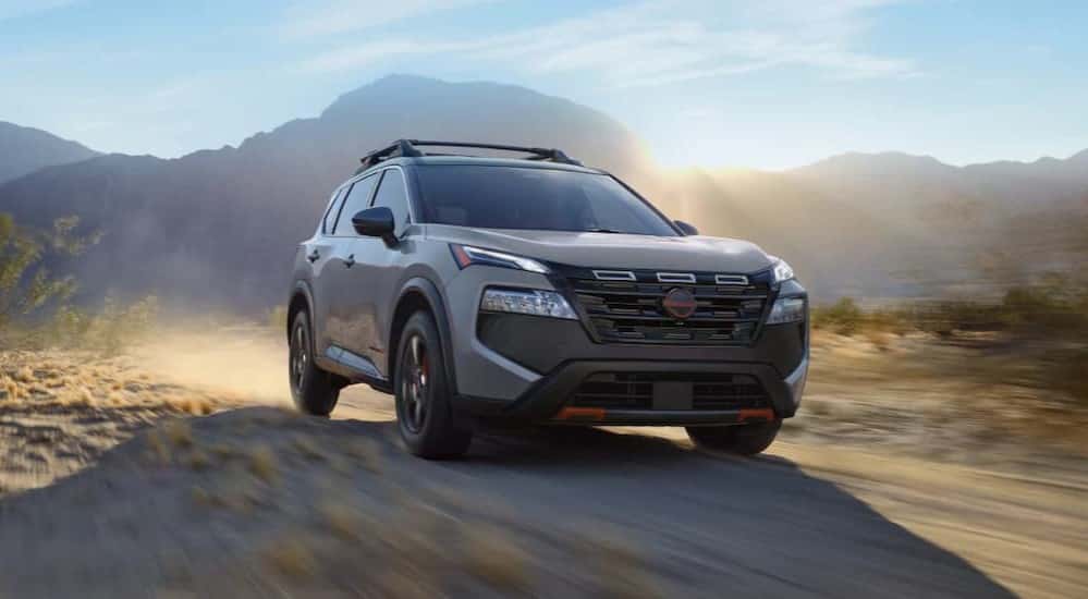 A tan 2025 Nissan Rogue Rock Creek is off-roading.