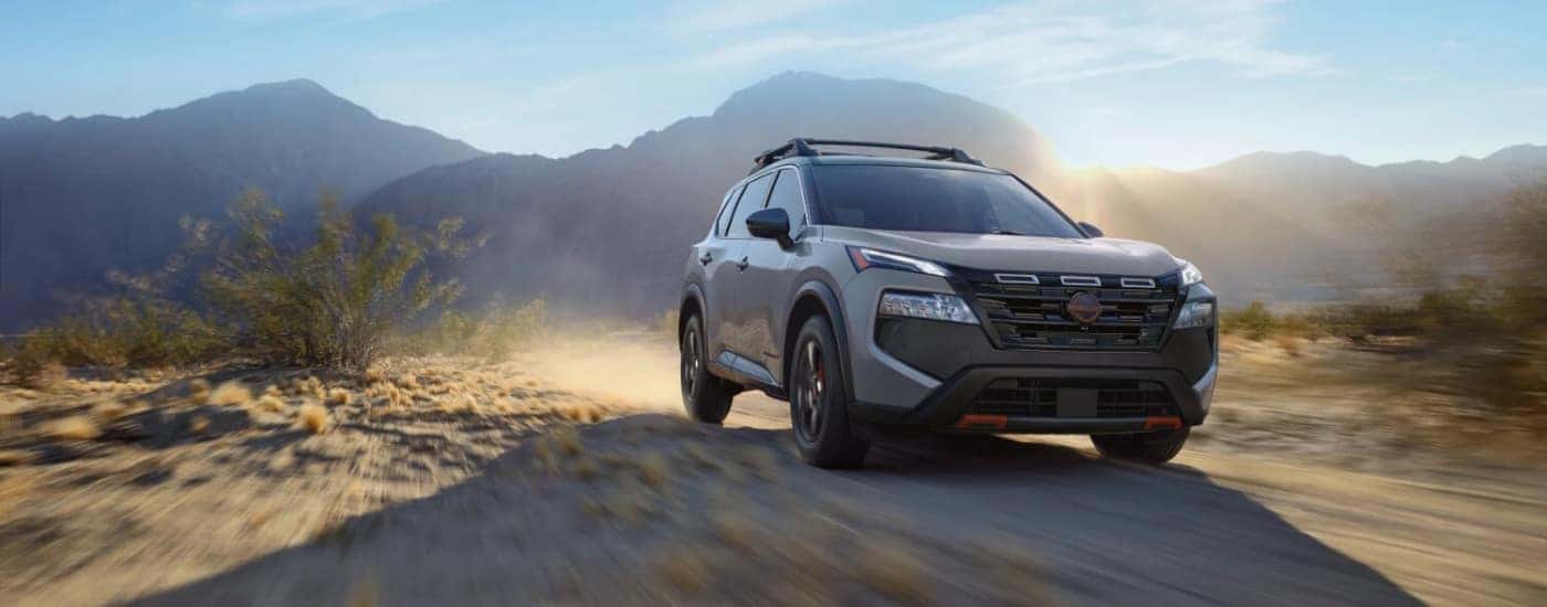 A grey 2025 Nissan Rogue for sale near Savoy from the front.