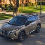 A parked bronze 2025 Nissan Rogue for sale near Savoy.