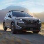 A gray 2025 Nissan Rogue Rock Creek driving off-road.