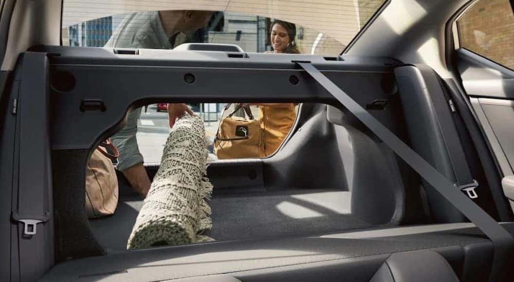A rug being stored in the rear cargo area in a 2025 Nissan Sentra.