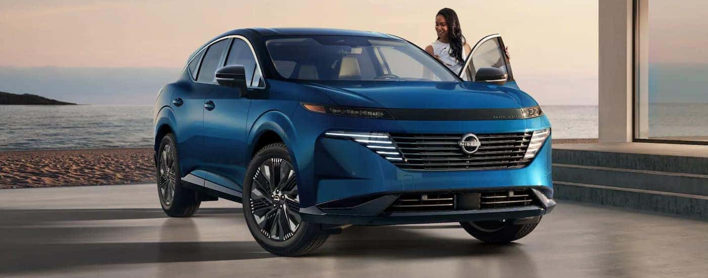 Woman getting into a blue 2025 Nissan Murano SL