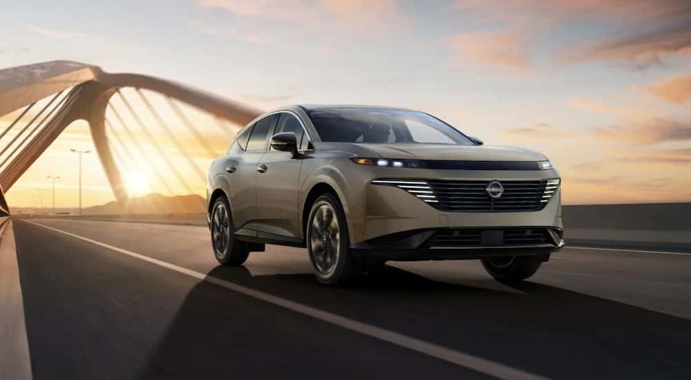 A tan 2025 Nissan Murano driving on a bridge.