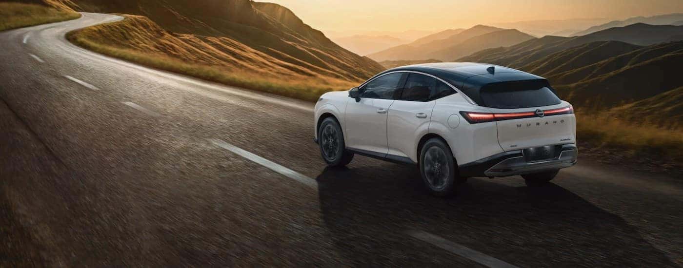 A white 2025 Nissan Murano driving on a highway.