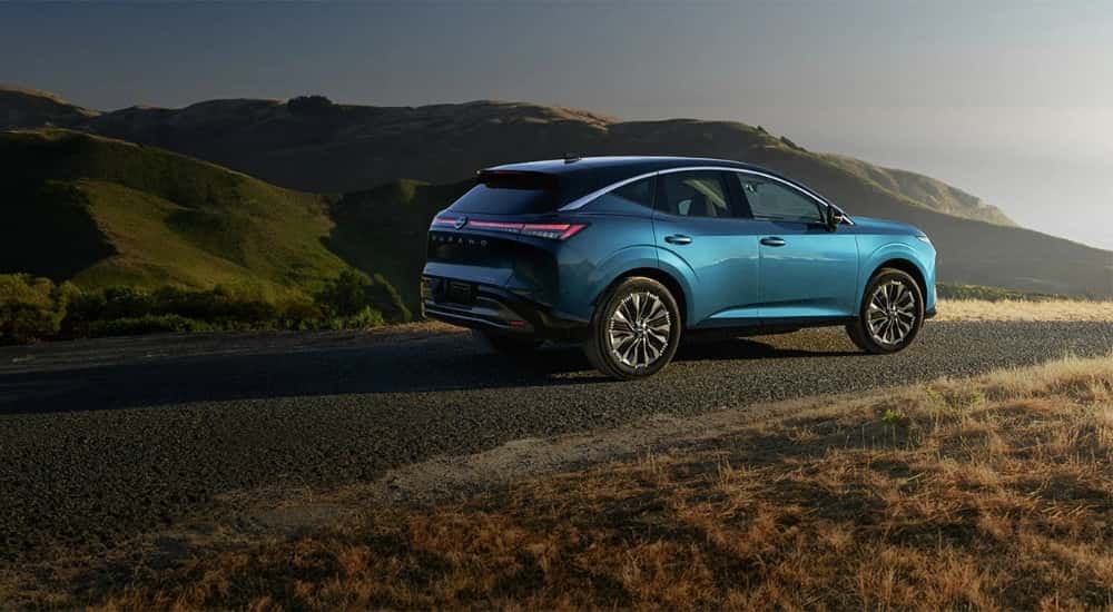 A blue 2025 Nissan Murano from the side.