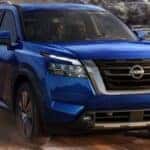 A blue 2022 Nissan Pathfinder off-roading.