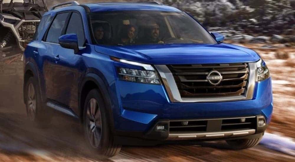 A blue 2022 Nissan Pathfinder off-roading.