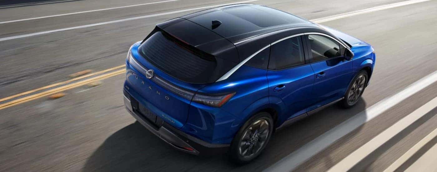 A blue 2024 Nissan Murano driving on a highway.