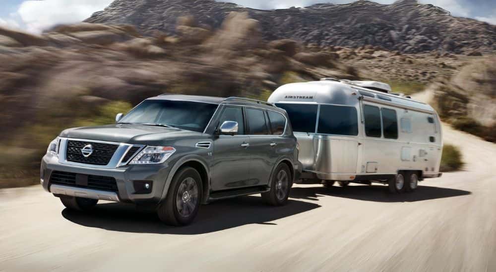 A gray used 2018 Nissan Armada towing an Airstream trailer