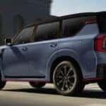 A blue 2026 Nissan Armada NISMO driving in a city