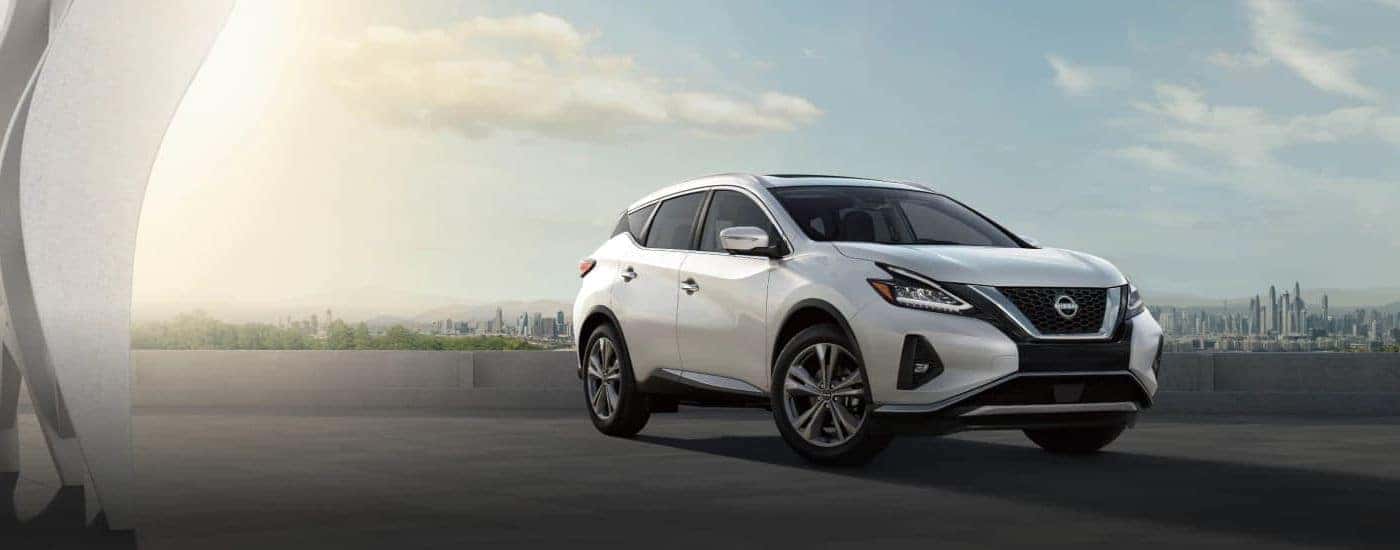 A white used 2023 Nissan Murano parked outside a city