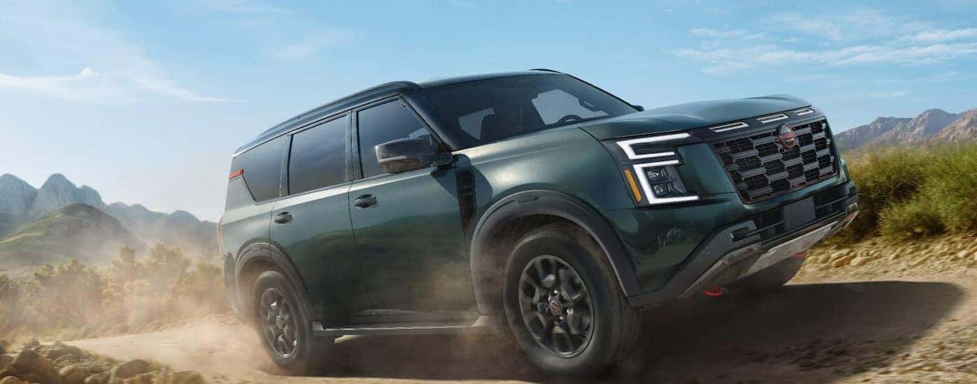 A green 2026 Nissan Armada off-roading