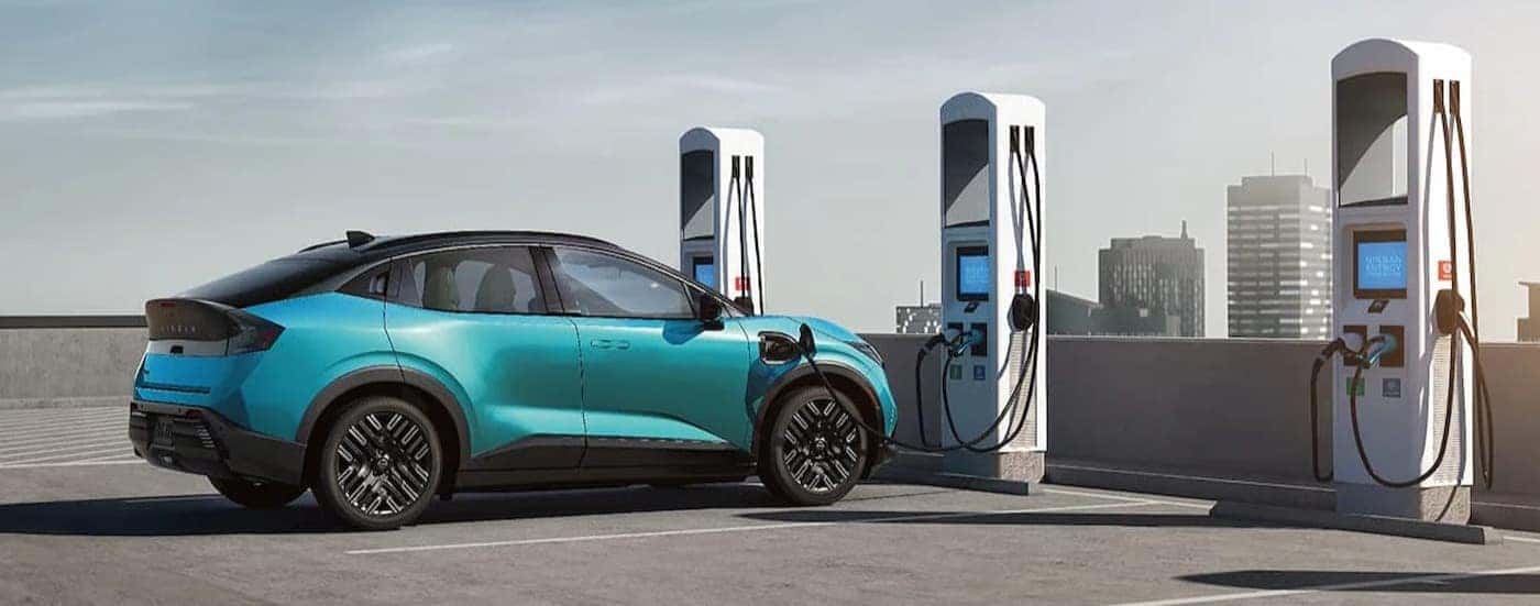 An aqua 2026 Nissan LEAF charging.