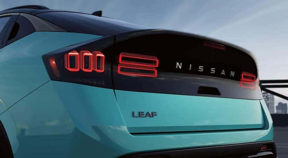 The rear-end of an aqua 2026 Nissan LEAF.