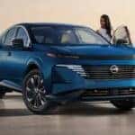 A person entering a blue 2025 Nissan Murano.