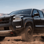 Black 2026 Nissan Frontier driving off-road